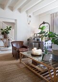 Brown leather armchair in elegant country-house-style living area with view into hallway