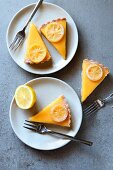 Lemon tart slices served on white plates