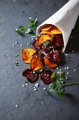 Homemade sweet potato and beetroot crisps in a paper bag