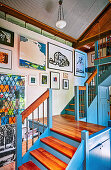 Art gallery in the stairwell with blue painted front