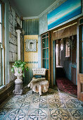Animal fur and amphora chair with houseplant in vintage ambience with ornamental tiles