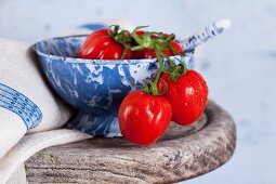 Small plum tomatoes in a ceramic bowl