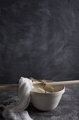 Ricotta in a cheesecloth draining into a bowl