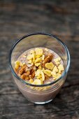 Cocoa pudding with walnuts and flakes in a glass