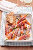 Carrots wrapped in parma ham