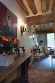 Rustic wood-beamed ceiling in living area with historical ambiance