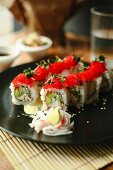 Sushi rolls with cucumber and flying fish roe