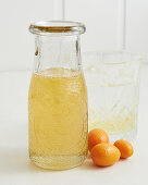 Kumquat syrup in a screw-top bottle