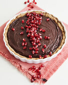 A chocolate cake with pomegranate seeds