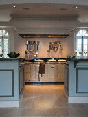 Opening between two kitchen counters leading to large AGA cooker in kitchen