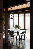 Table and chairs in front of a window in the dining area with slate tiles