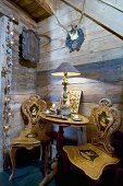 Antique wooden chair and small table against wooden wall in chalet