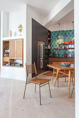 Angled walls and fitted cupboards in open-plan kitchen