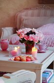 Coffee table romantically set with vase of roses and macarons