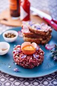 Beef tartare with egg and oyster plant flowers