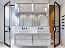 Marble washstand and wall-mounted mirrors in elegant bathroom