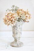 Dried hydrangeas and gypsophila in stone vase