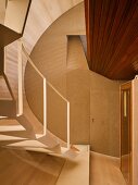 Wood-clad stairwell with designer stairs and doorway