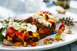 Grilled bread topped with mediterranean vegetables and feta