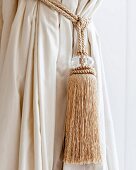 Cream tassel on curtain tie-back cord