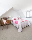 Pink accents in attic bedroom