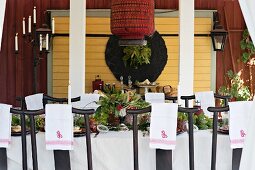 Monogrammed napkins on backrests of chairs at festively set table