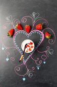 A strawberry dessert on a decorated blackboard