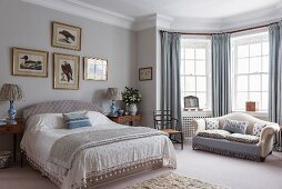 Elegant bedroom with sofa in window bay