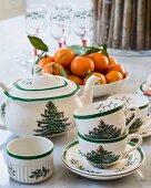 Tea service with Christmas-tree pattern and bowl of tangerines