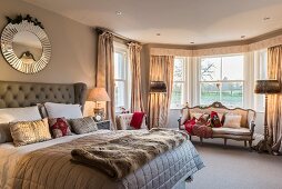 Baroque sofa in window bay in elegant bedroom