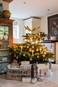 Christmas presents around Christmas tree decorated with candles and orange slices