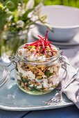 Rice salad with nuts, seeds, feta, coriander and mint in a screw-top jar