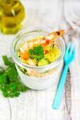 Couscous with a prawn and courgette in a glass jar