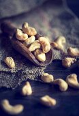 An arrangement of cashew nuts on a wooden scoop