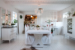 Set table in dining room decorated entirely in white