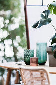 Green vases with relief and monster plant on the table