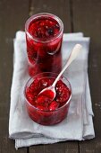 Homemade berry jam with cherries and apricots in jars