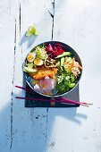 A summery Asian bowl with soba noodles, quail eggs and chicken schnitzel