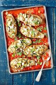 Aubergines stuffed with rice, courgette and feta baked with tomato sauce