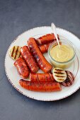 Grilled sausages with onion and mustard