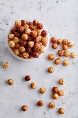 Corn pops in a plastic tub and on a marble background