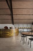 Curved metal bar in renovated vineyard farmhouse