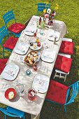 A table set with a paper tablecloth and a menus in a garden