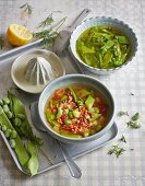 Green bean soup two ways: with dried tomatoes and bacon and with sugar snap peas and capers