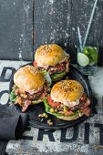 Burgers with beef, cocktail mayo, bacon, and pineapple salsa