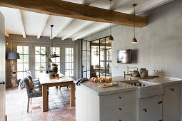 View from kitchen into dining room with terracotta floor tiles