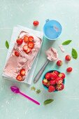 Homemade strawberry ice cream with fresh strawberries and mint