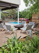 Outdoor chairs around fire pit on wooden deck