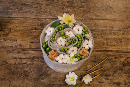 Felt spiral filled with cotton bolls, St. John's wort and hellebores