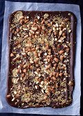 Chocolate with almonds, sea salt, and roasted millet on baking paper
